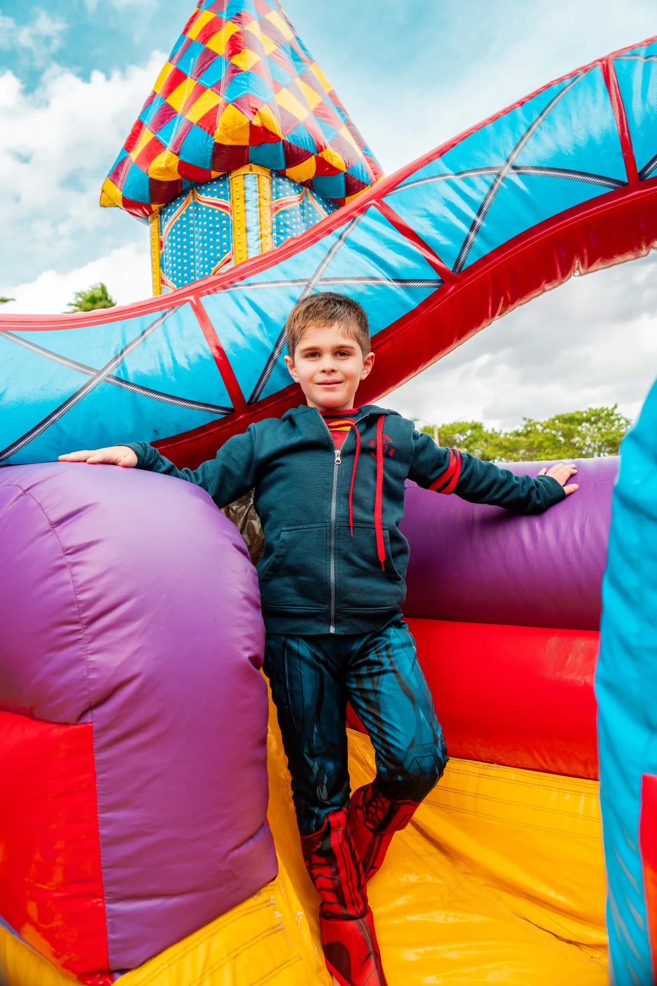 Boy at an inflatable slide at a birthday party