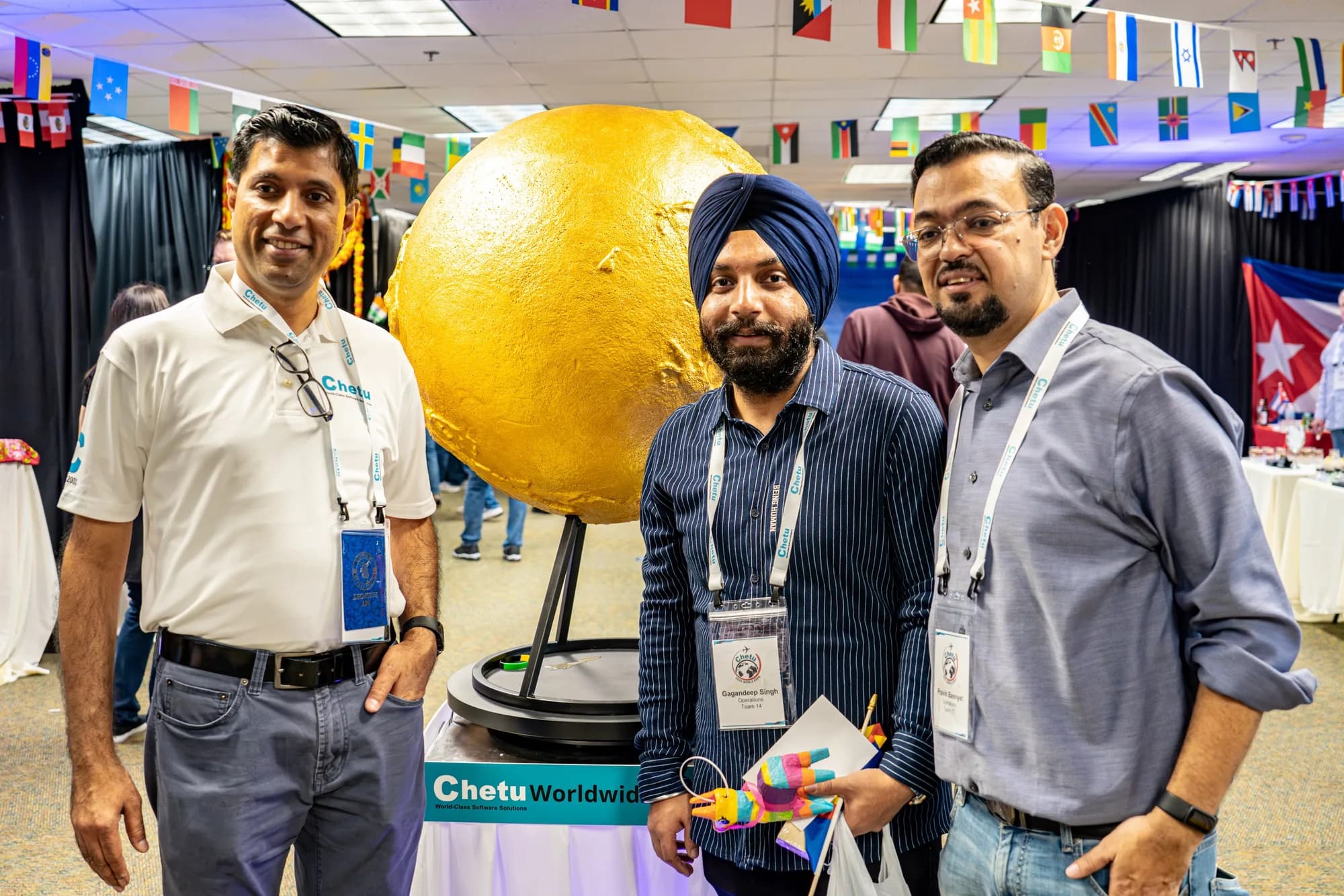 Attendees beside a globe display at a South Florida conference