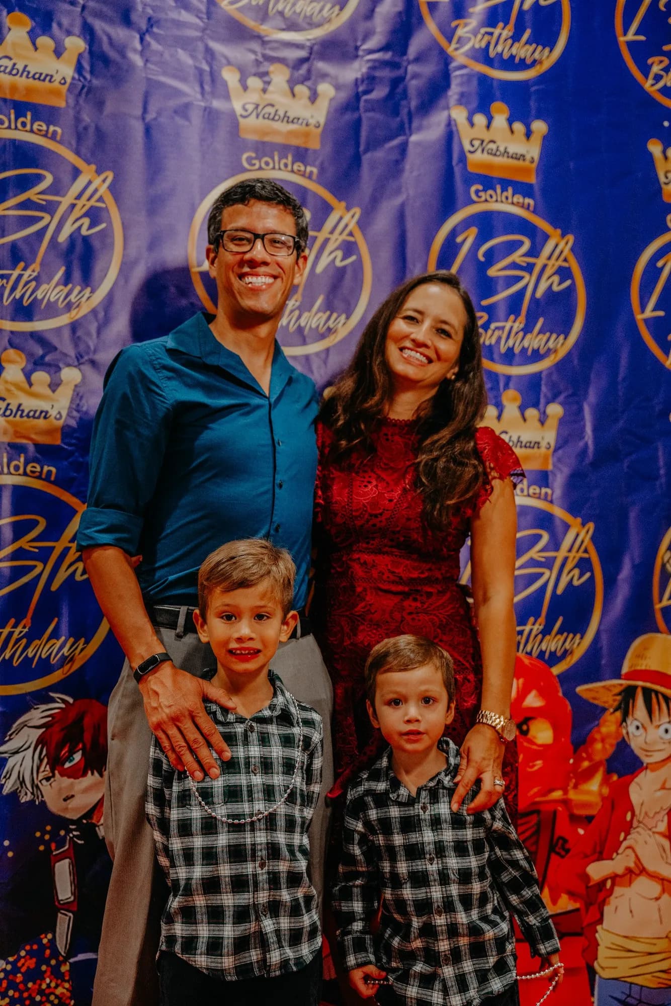 Family posing at a custom birthday backdrop
