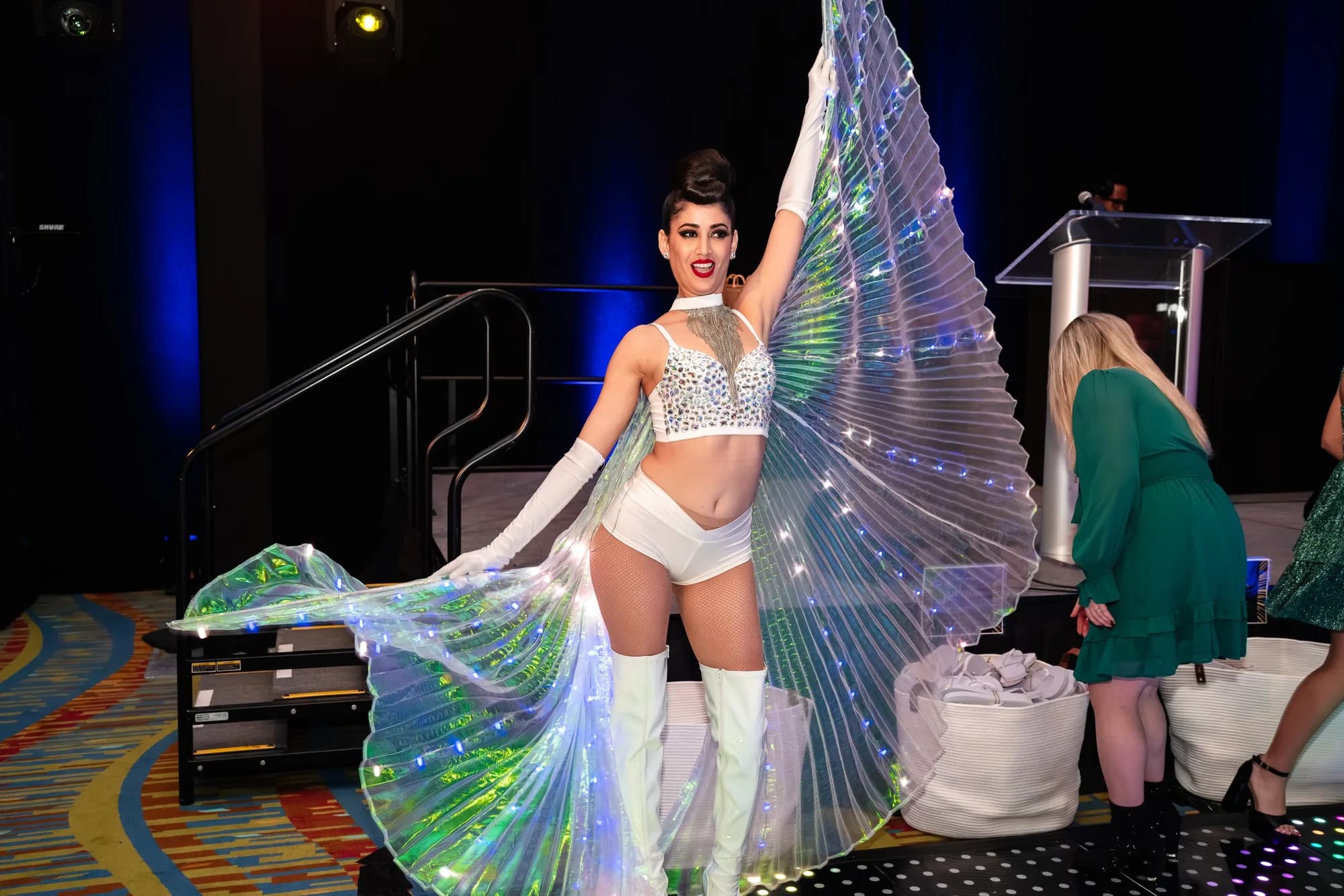 Performer with LED wings at a gala