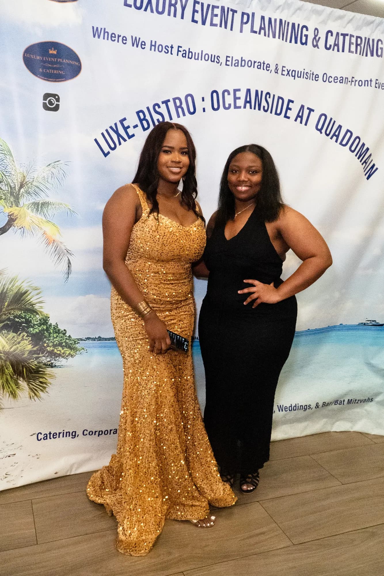 Graduate and guest at a step-and-repeat banner