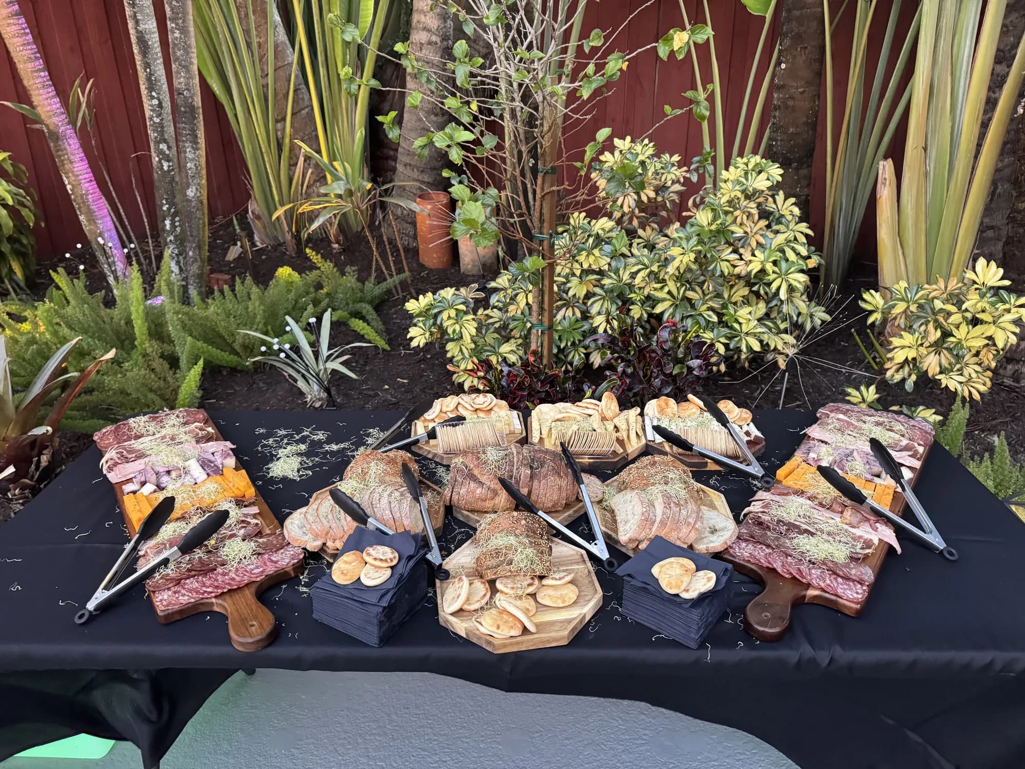 Grilled skewers and barbecue display at an outdoor catered event