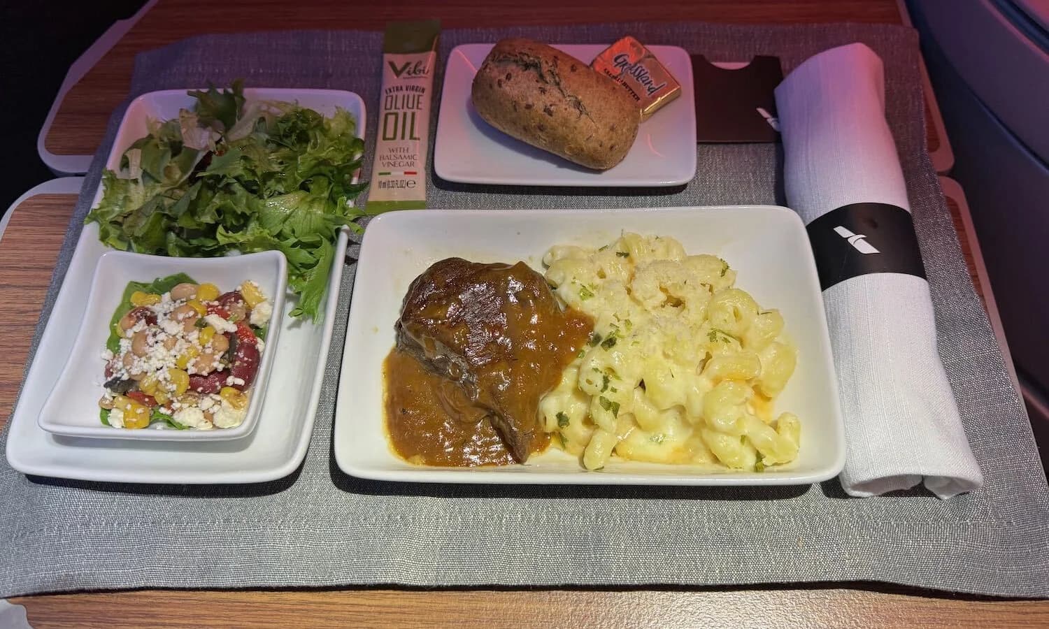 In-flight tray: seared beef with lobster mac and cheese, salad, marinated vegetables and a bread roll