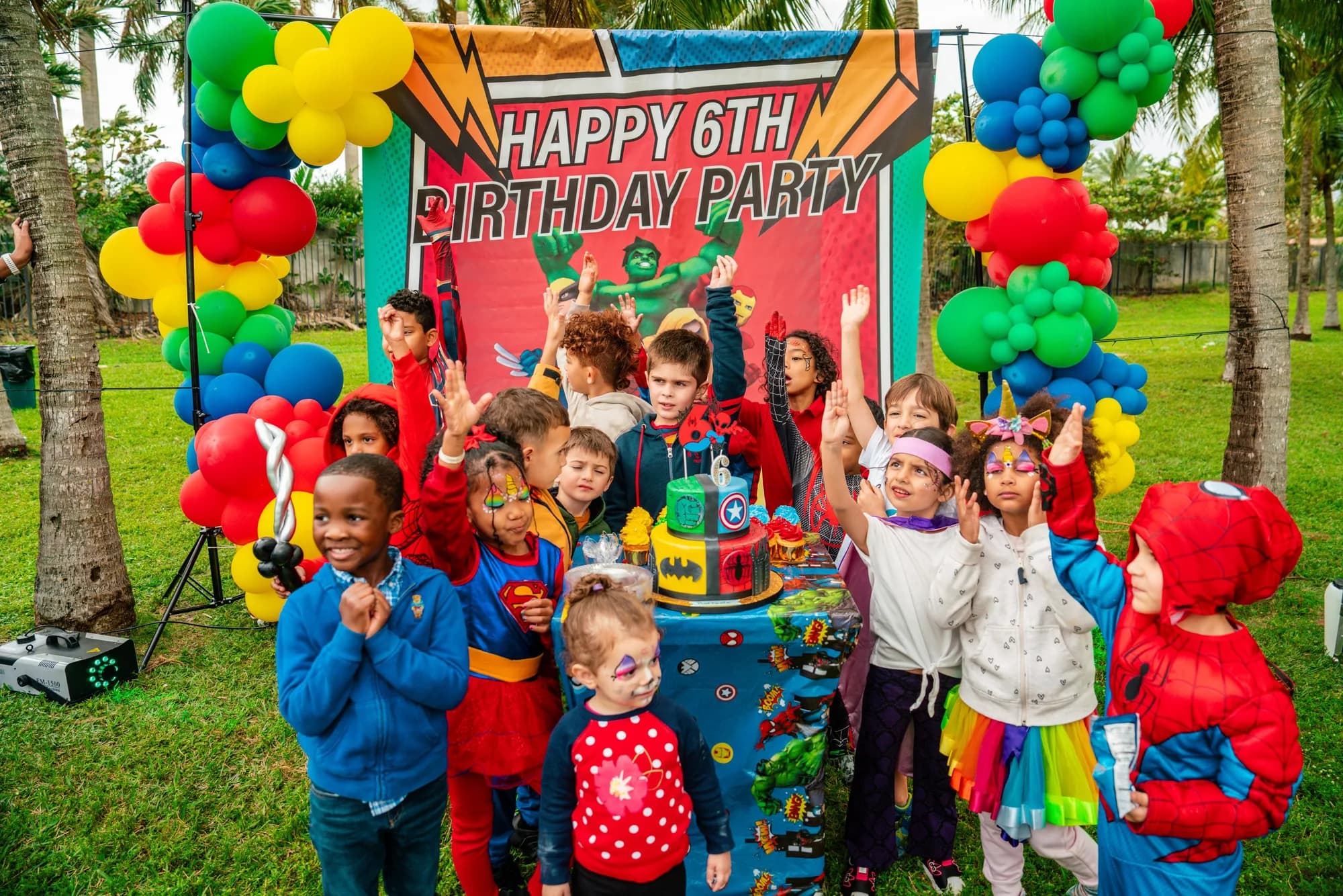 Kids at a 6th birthday balloon backdrop