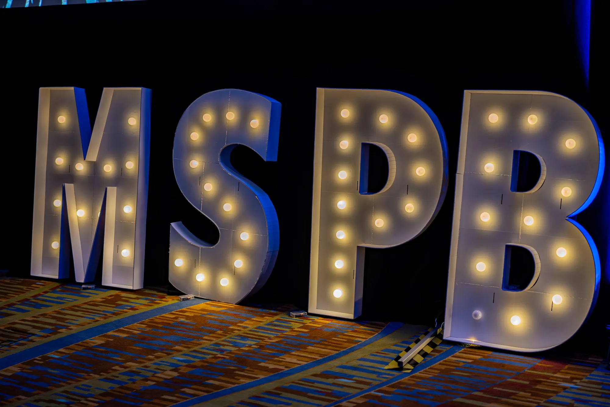 Illuminated marquee letters at a gala