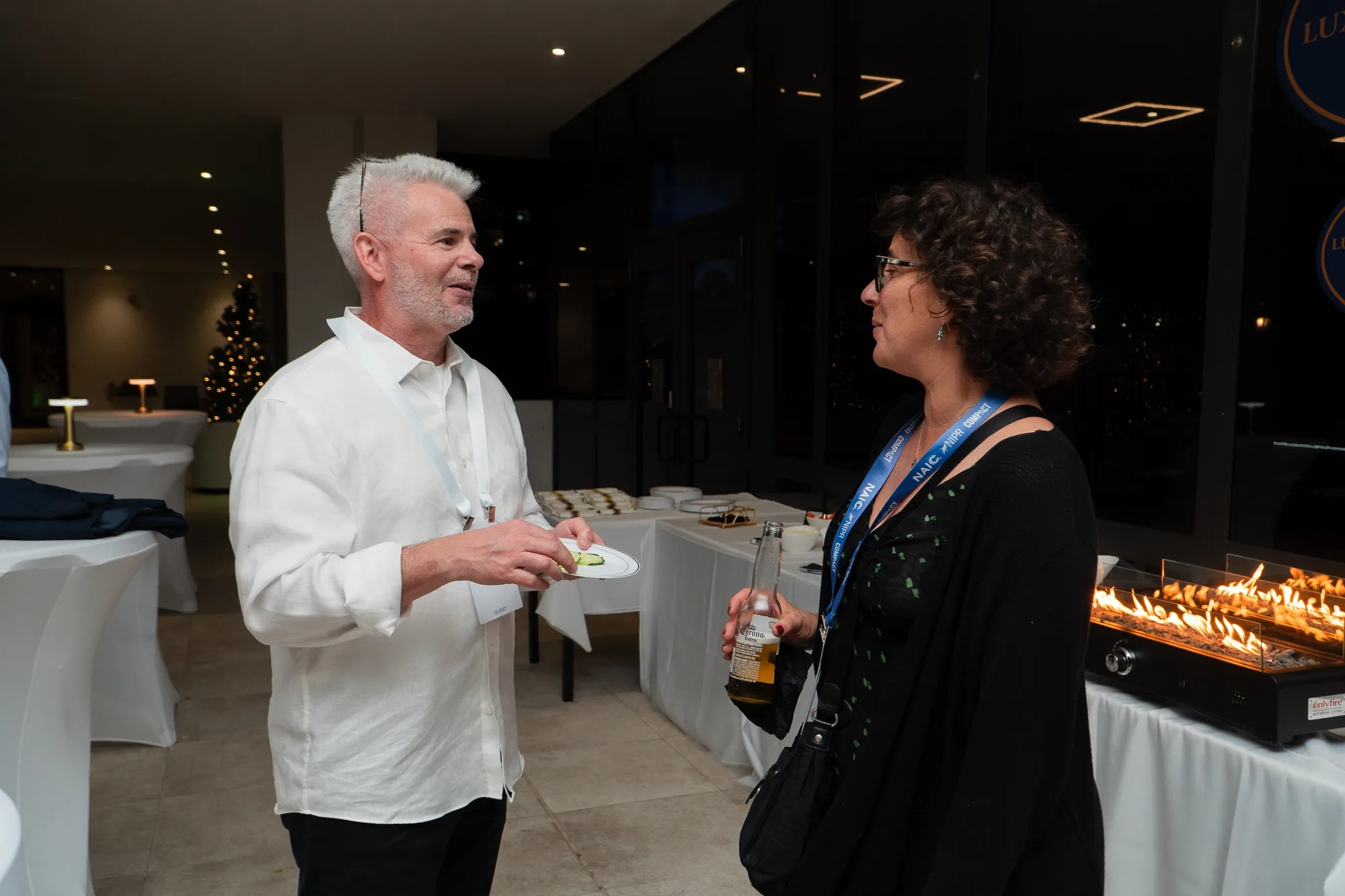 Two guests chatting at a catered reception