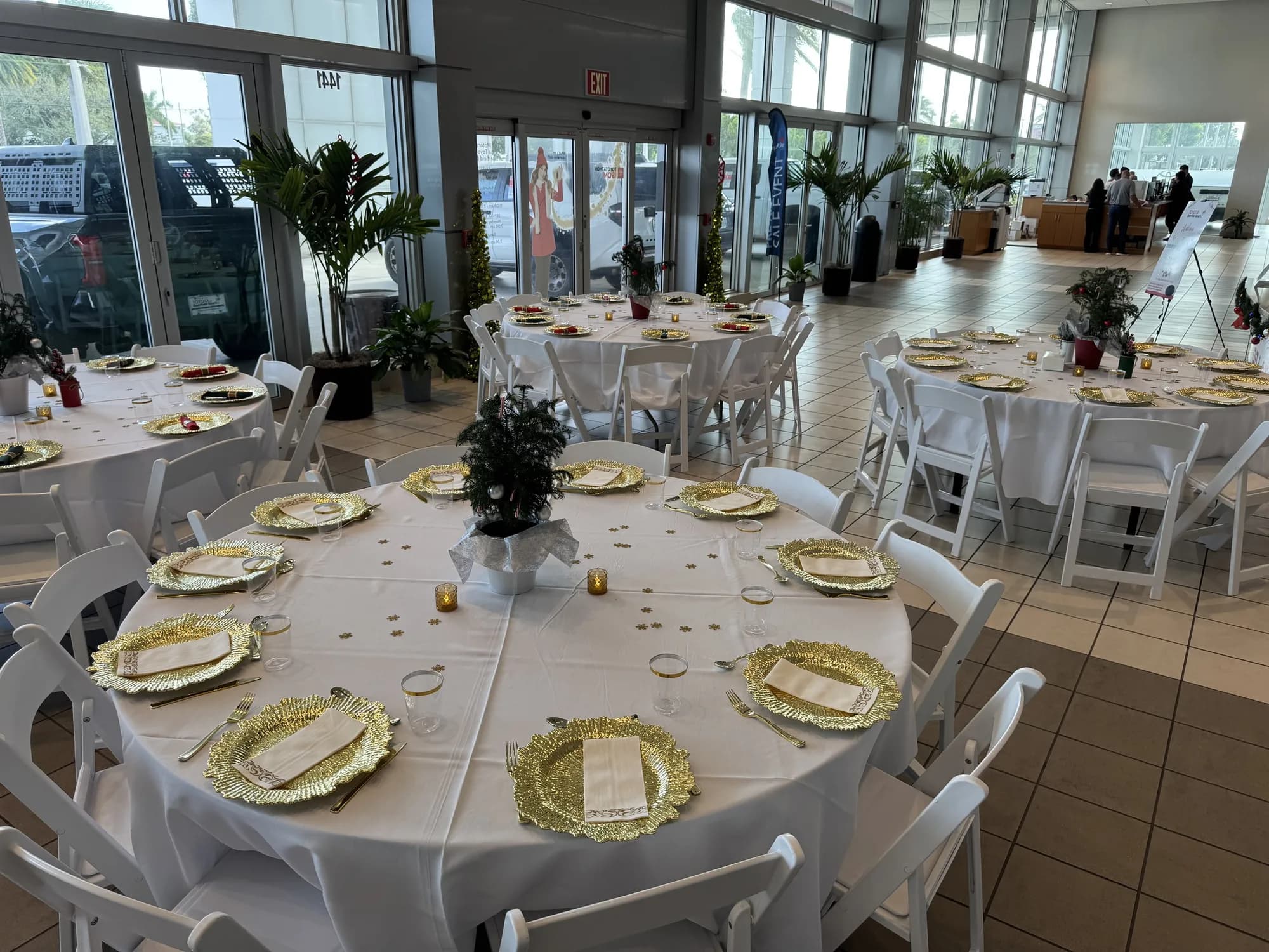 Round tables set with gold chargers for a showroom dinner