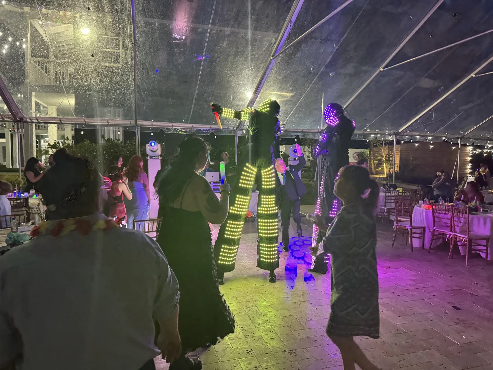 Tent wedding reception with stilt performers