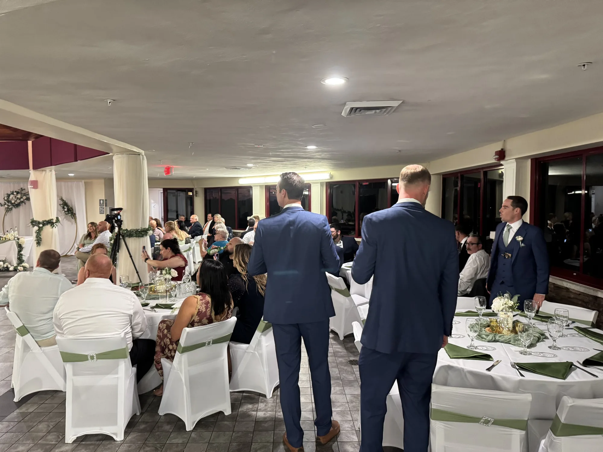 Wedding reception in a ballroom with white chair covers